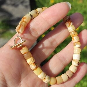 102 Real butterscotch amber bracelet with a stylish gold-tone clasp.